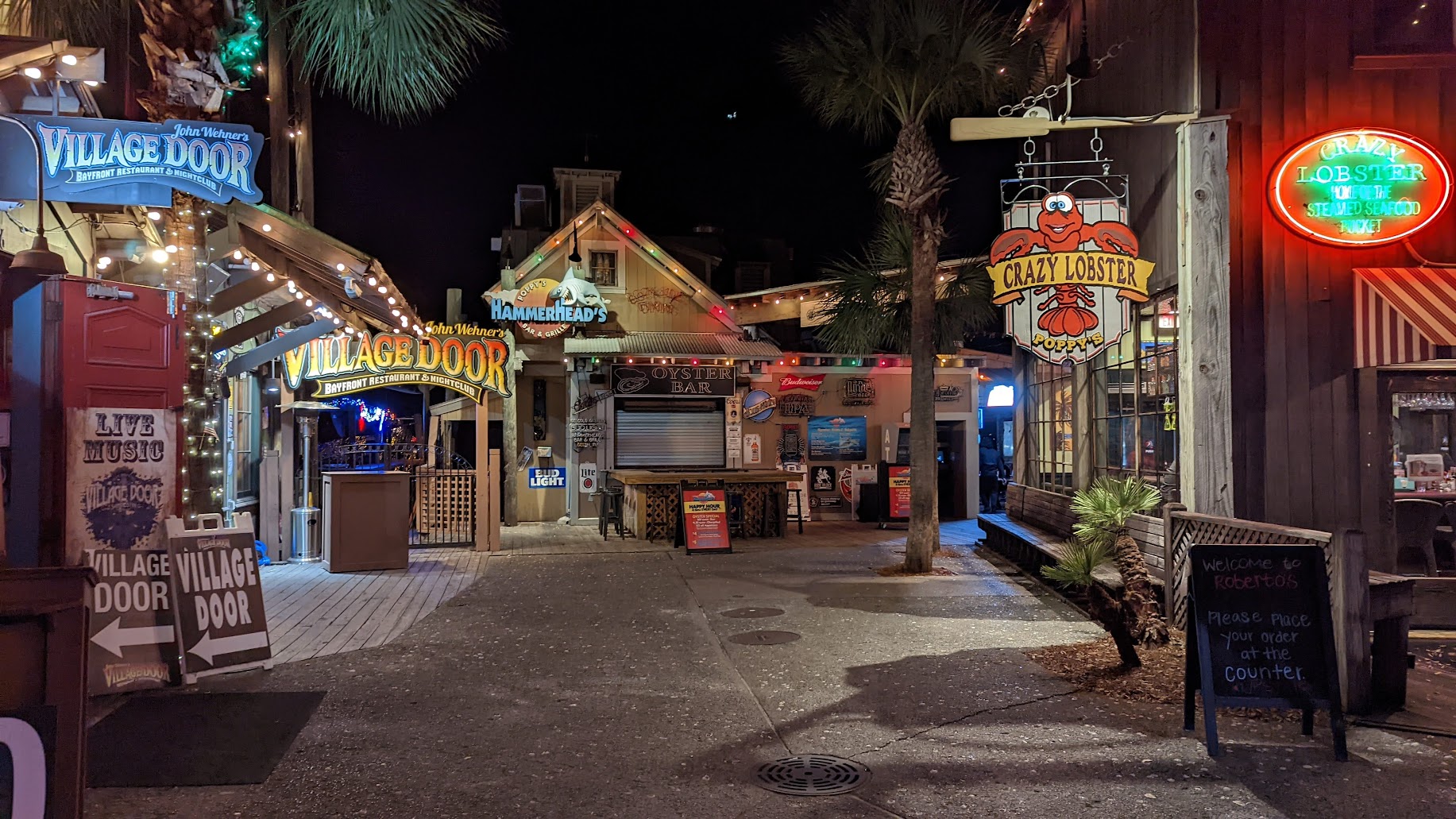 HarborWalk Village at night in Destin