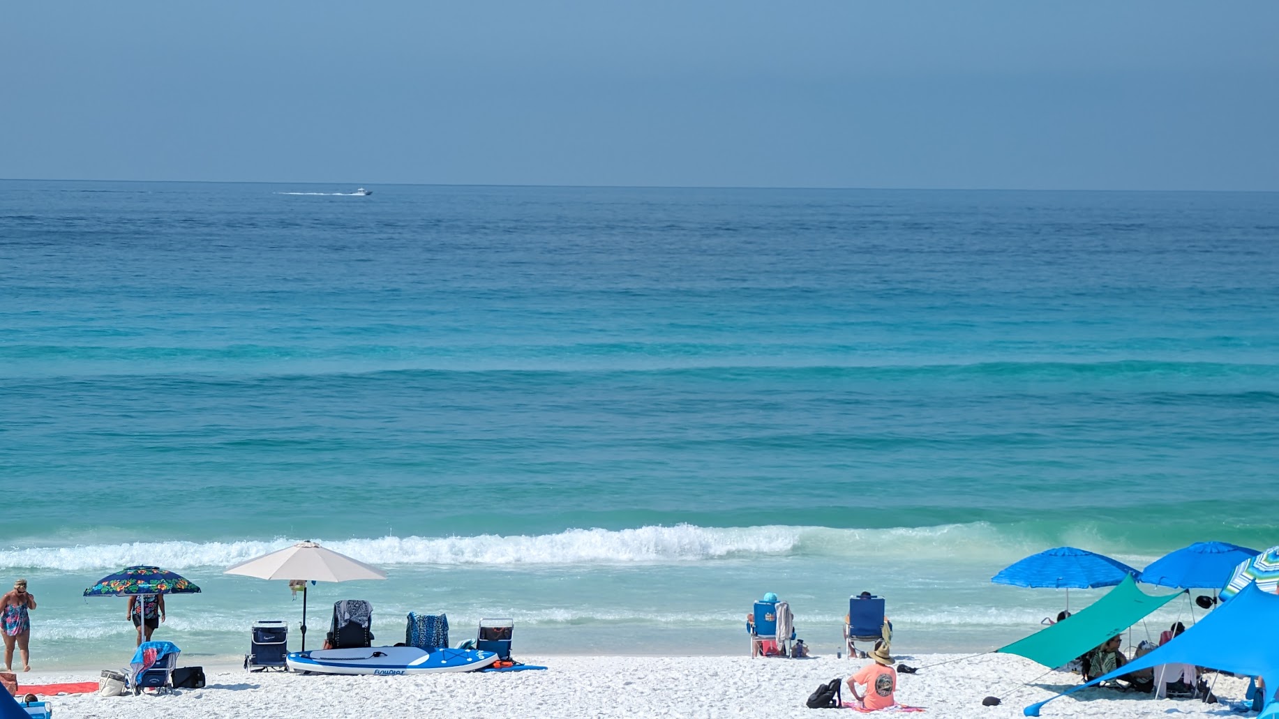 Peaceful residential beachfront along Scenic Gulf Drive in Miramar Beach Florida at golden hour with calm emerald Gulf water and beach houses behind dunes