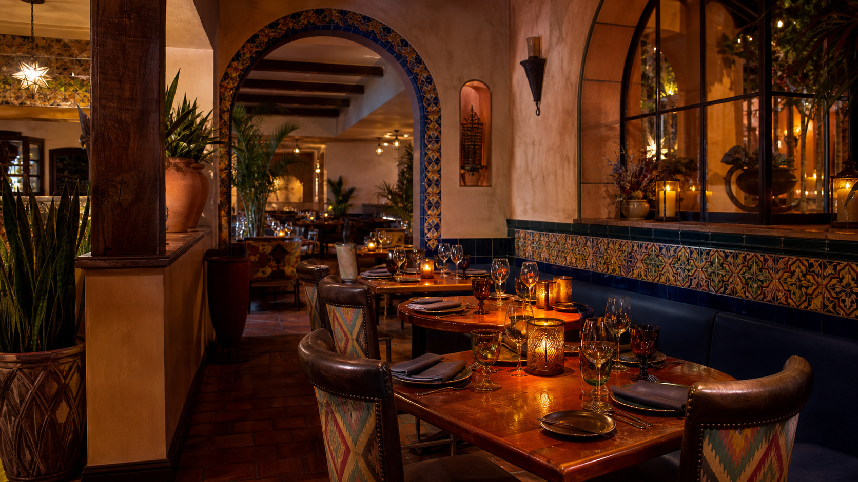 Warm Mexican restaurant dining room in Destin Florida with colorful tile accents, soft lighting and couples at candlelit tables