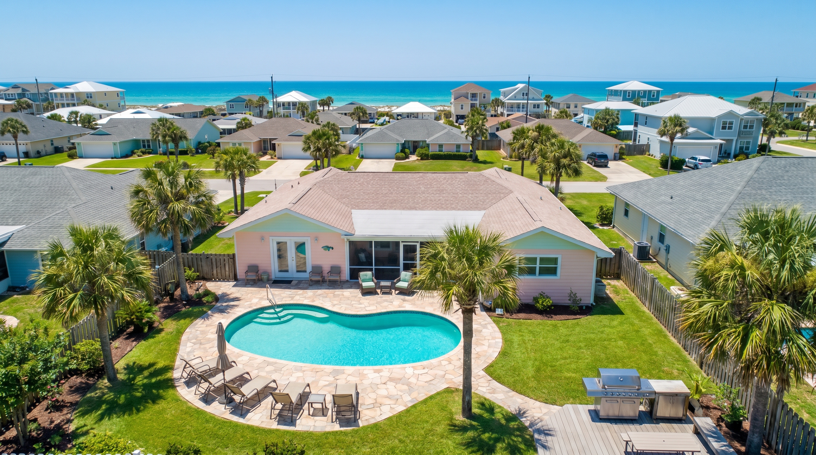Aerial view of a Miramar Beach vacation rental home with private pool and palm trees