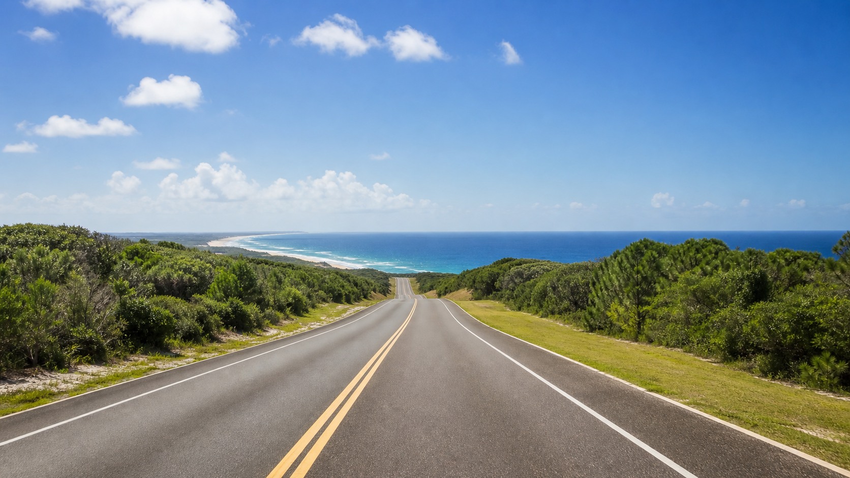 Open highway road trip through the Florida panhandle on a clear sunny summer day with palm trees, blue sky, and the road stretching ahead toward a beach vacation