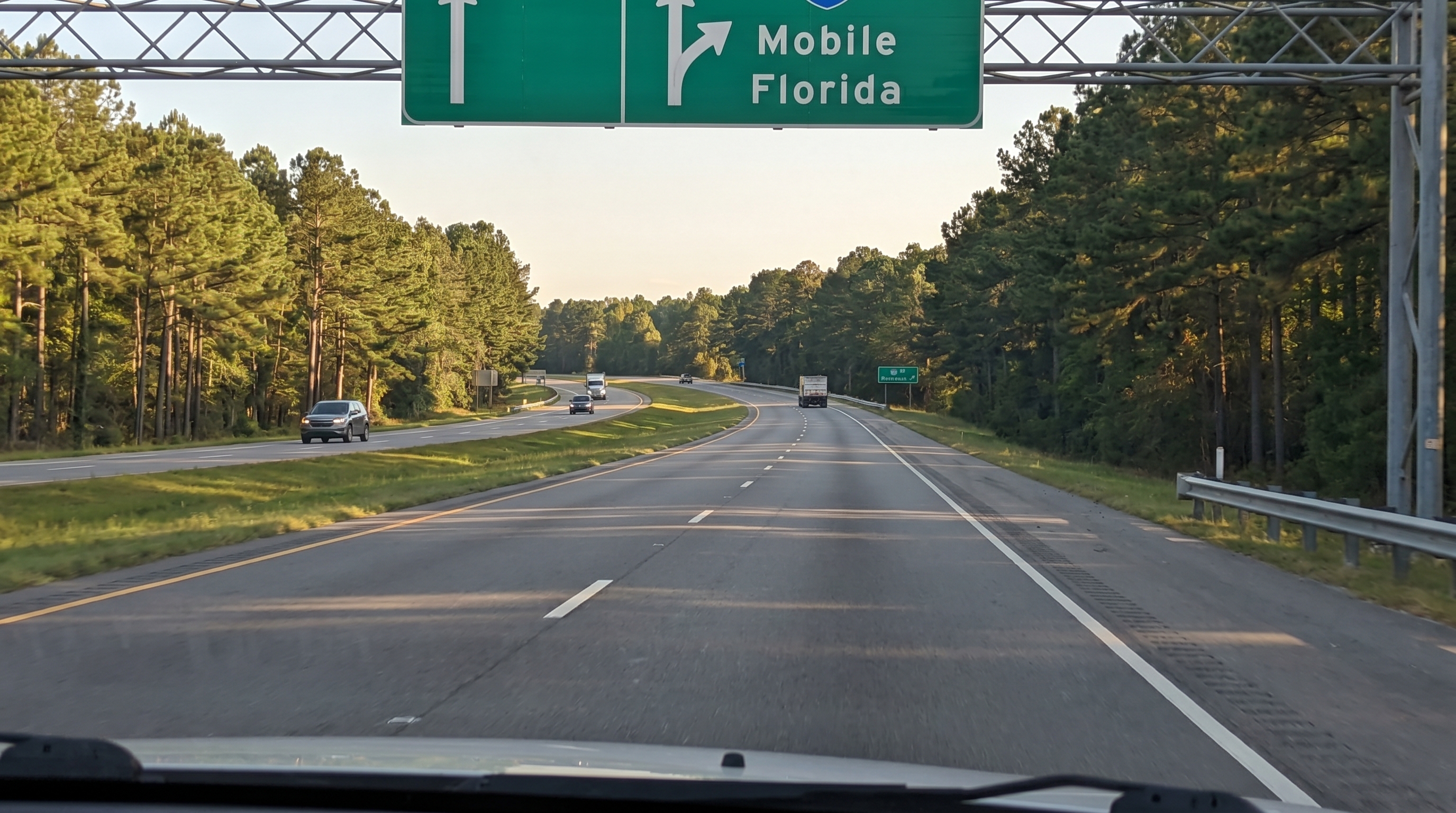 Interstate highway cutting through green rolling hills in the American South on the route from Ohio to Florida