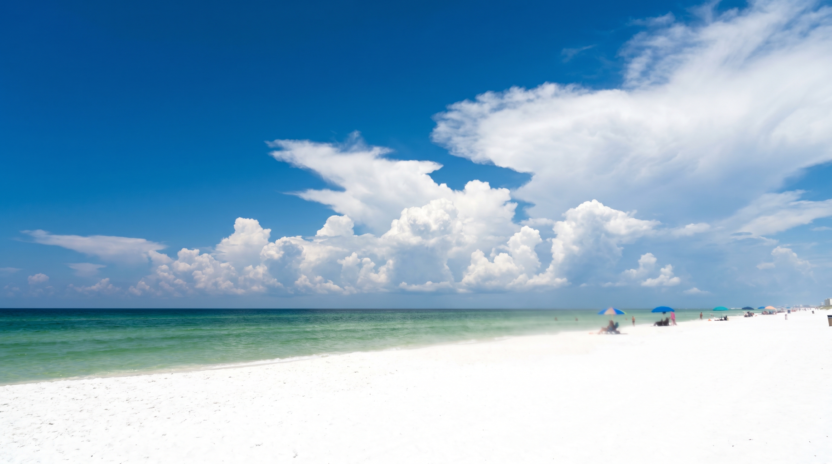 Brilliant blue sky and white sand beach in Destin Florida on a hot July morning with calm emerald Gulf water