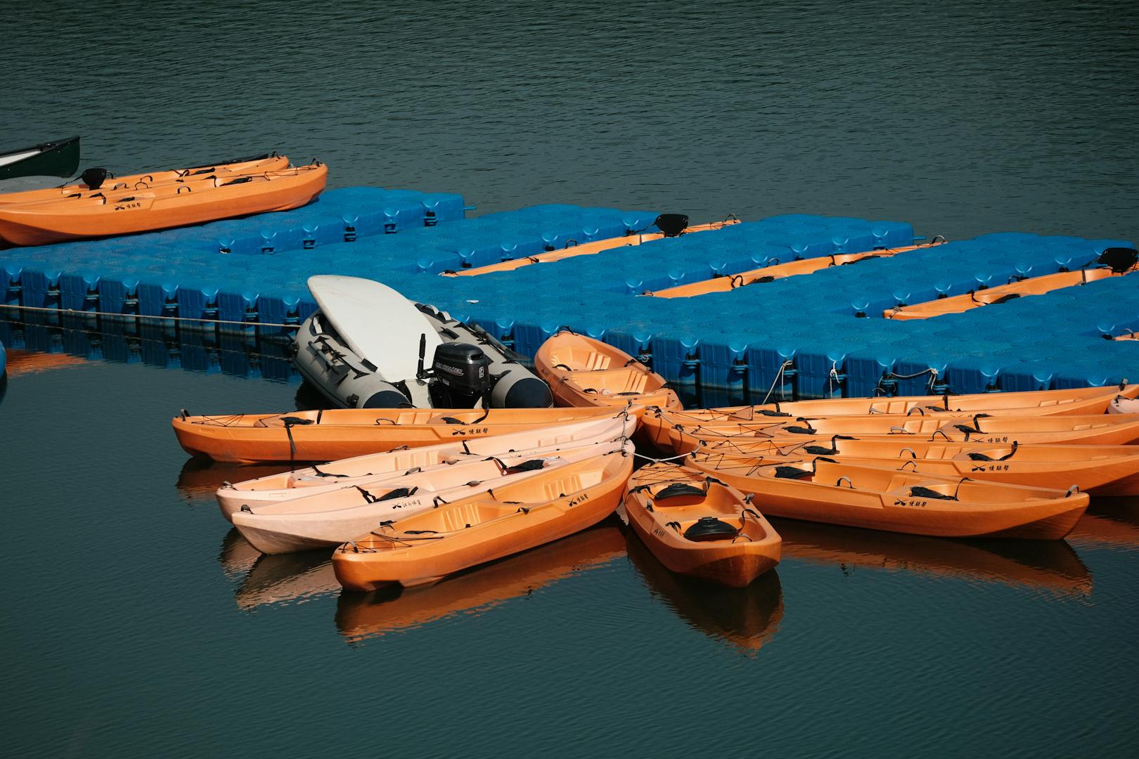 Colorful kayaks and paddleboards lined up at a rental outfitter on the Destin Florida waterfront