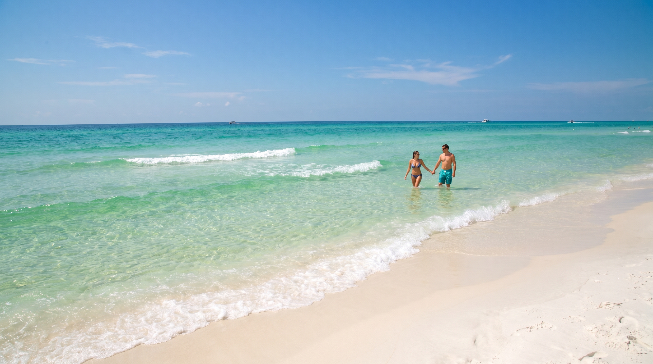 Crystal clear emerald green Gulf of Mexico water at Destin Florida in early September with calm conditions and white sand