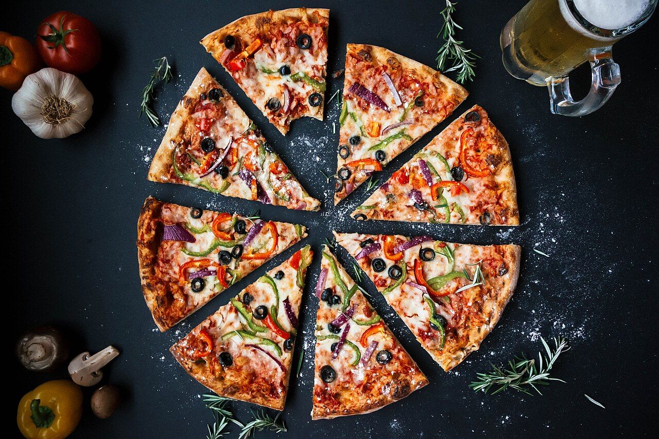 Large New York-style pizza with crispy crust and generous toppings at Piezoni&rsquo;s in Destin Florida