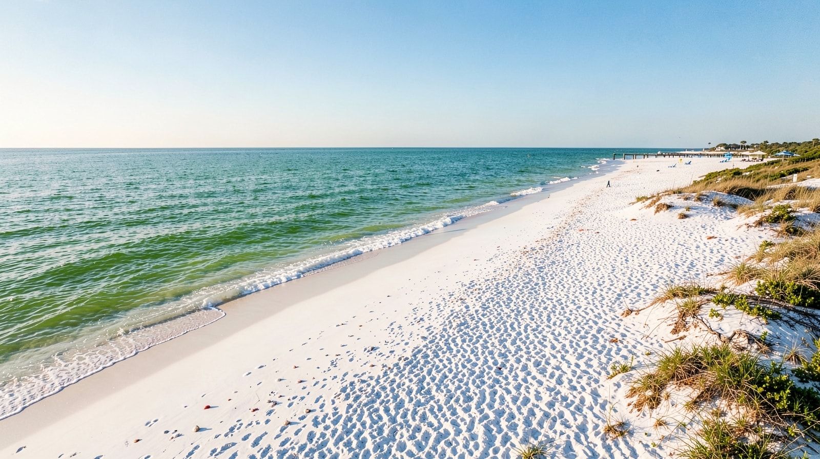 Aerial view of an uncrowded white-sand beach at Destin Florida with emerald Gulf water in late September