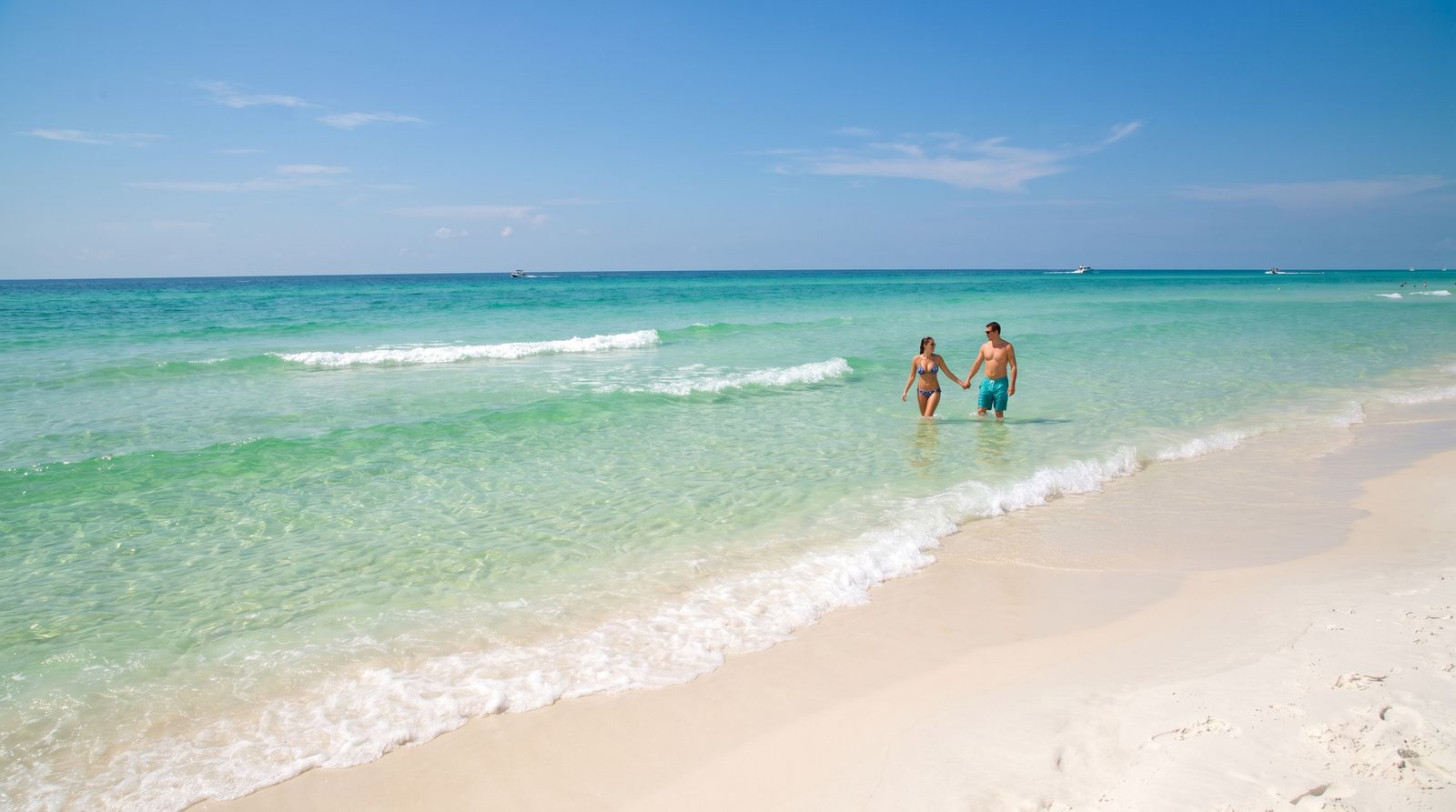 Crystal clear emerald green Gulf of Mexico water at Destin Florida in early September with calm conditions and white sand