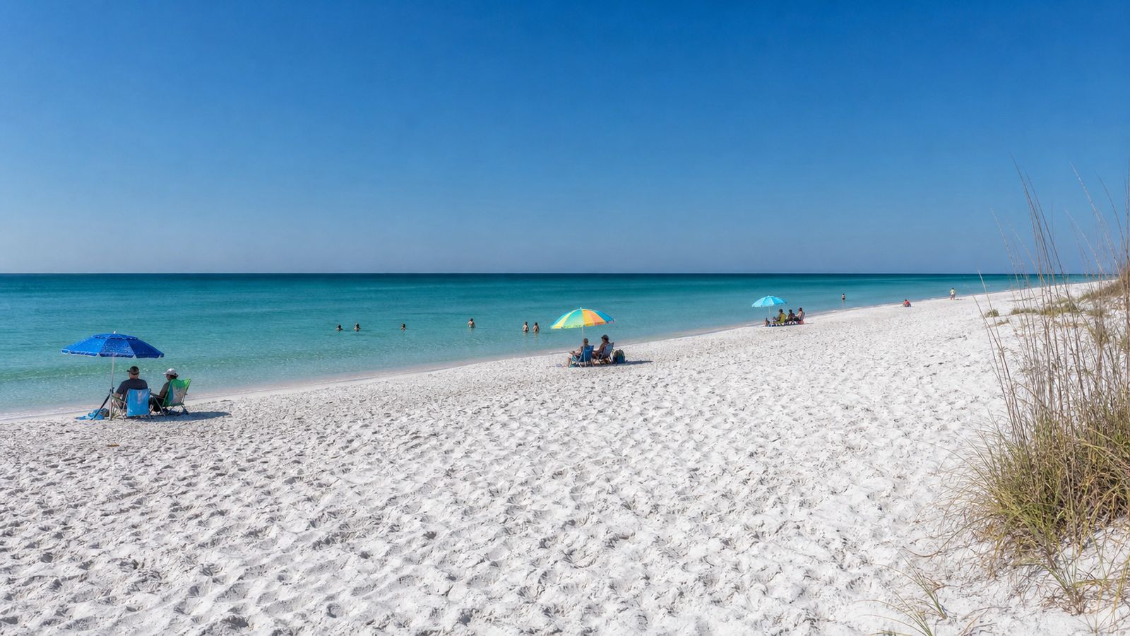 Uncrowded white sand beach with emerald green Gulf water on Florida's Emerald Coast near Miramar Beach